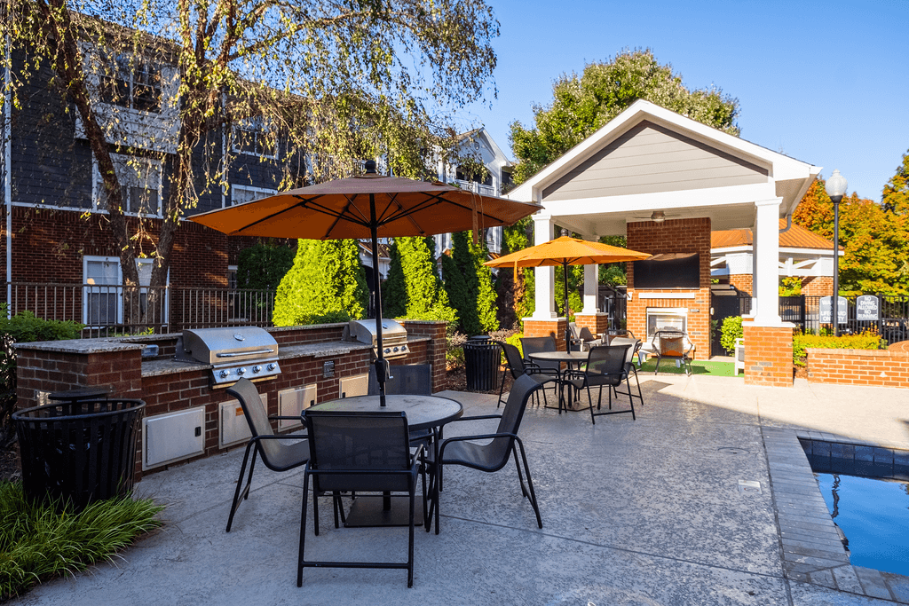our apartments have a large patio with tables and umbrellas