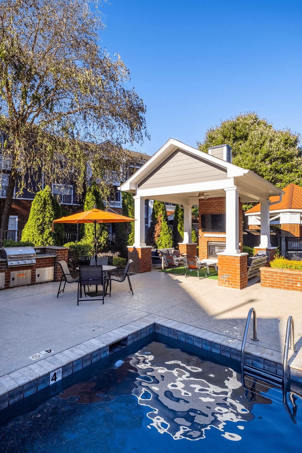 a swimming pool with a patio and a house with a pool