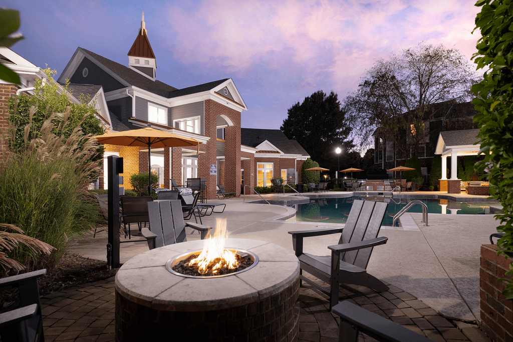 A backyard with a fire pit and a pool.