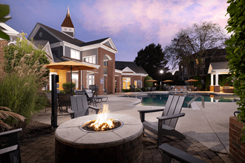 A backyard with a fire pit and a pool.