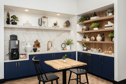 A kitchen with a table and chairs in the middle.