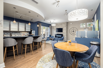 a dining room and kitchen with a table and chairs