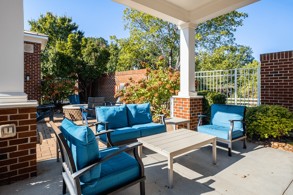the preserve at ballantyne commons spacious patio with blue chairs and tables