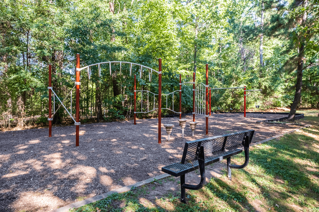 a playground with a swing set and a bench