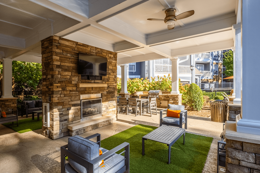 the preserve at ballantyne commons covered patio with fireplace and seating area
