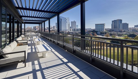 A long balcony with a view of the city.