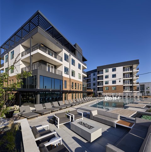 A modern building with a pool in front.