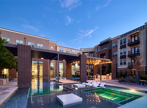 A modern building with a pool in front.