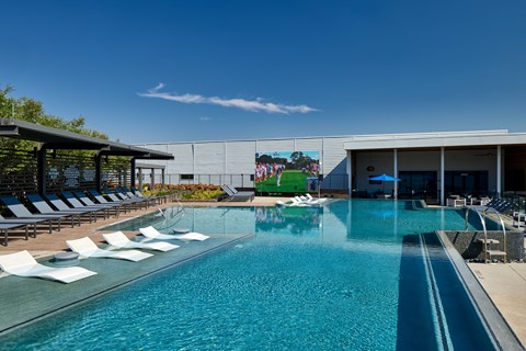 A large swimming pool with people swimming in it.