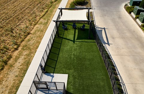 A soccer field with a goal post and a bench.