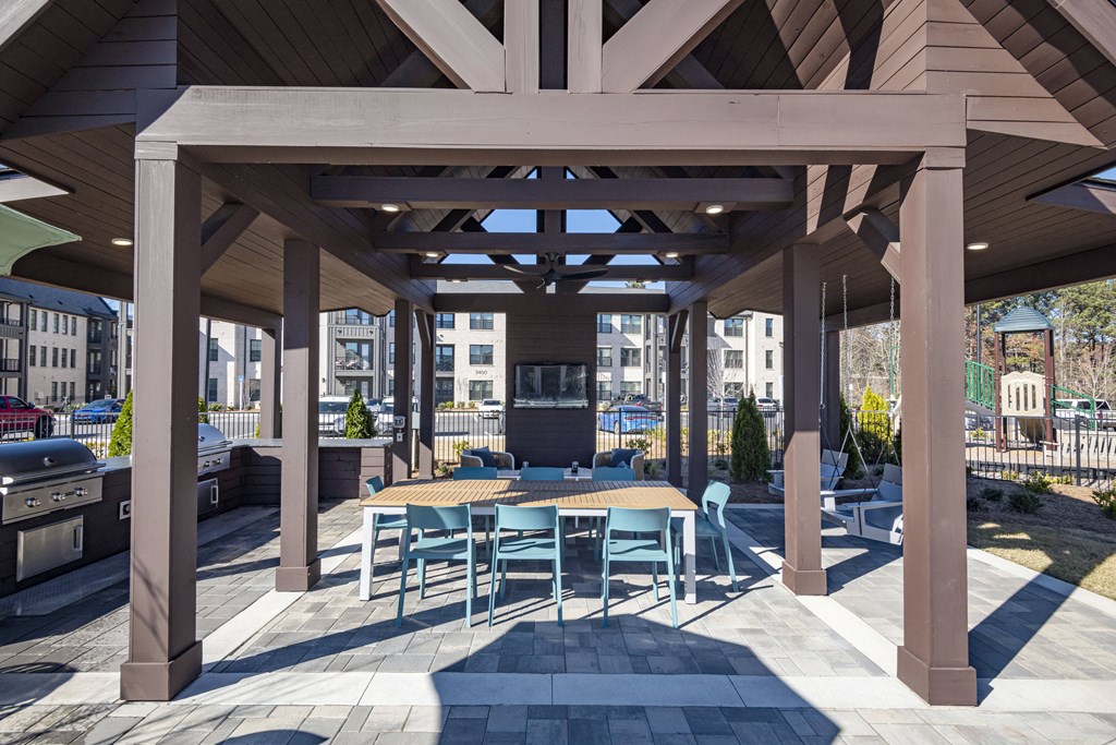 a large covered patio with tables and chairs