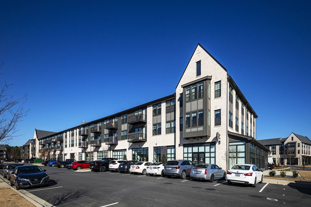 a large building with cars parked in a parking lot