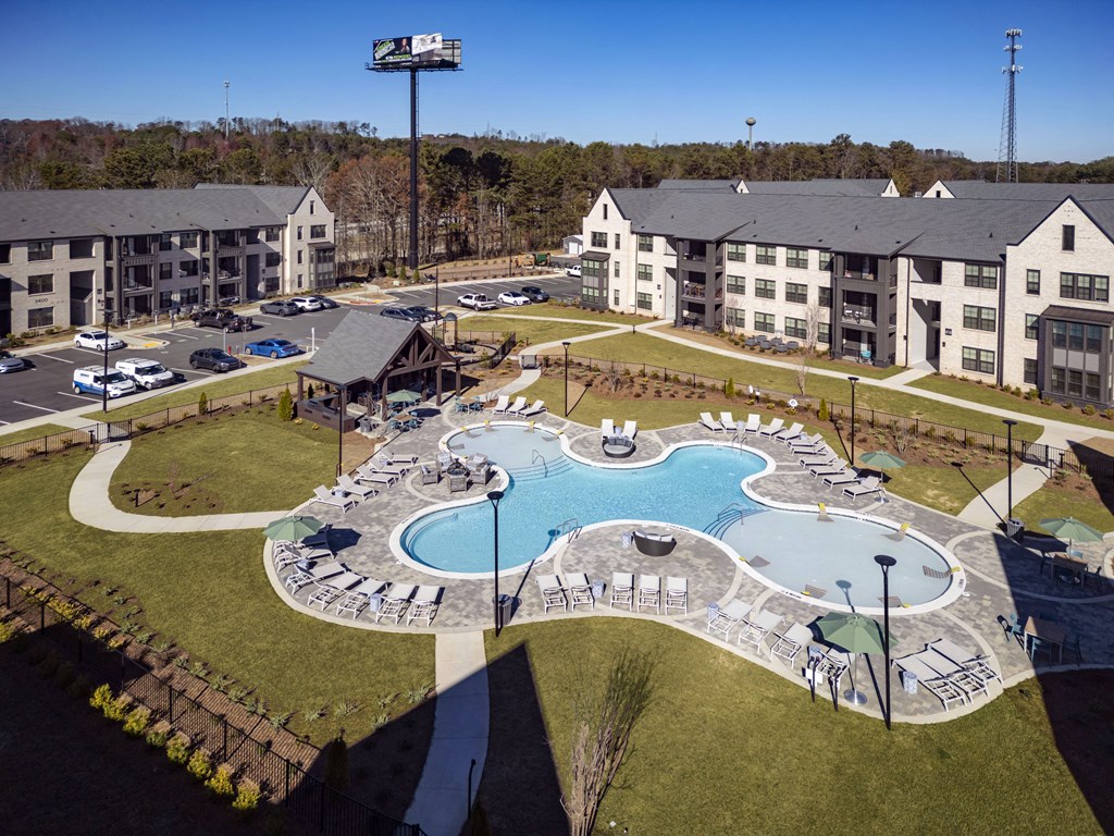 an aerial view of an apartment complex with an outdoor swimming pool