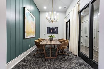 a dining room with a wooden table and chairs and a chandelier
