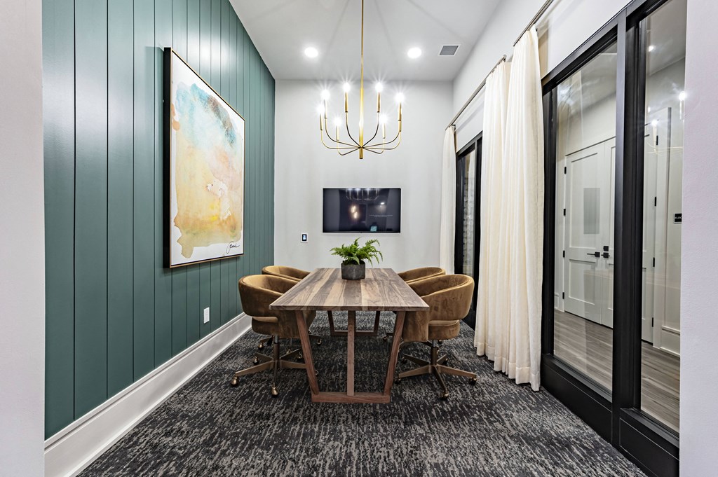 a dining room with a wooden table and chairs and a chandelier