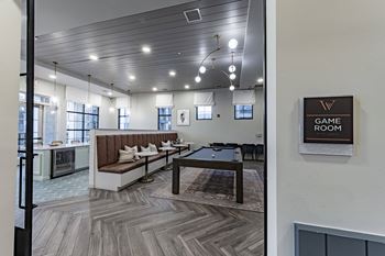 a clubhouse with a pool table and a game room
