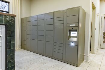 a large set of lockers in a room with a tile floor and a door