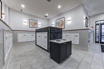 a locker room with white cabinets and counters and a black counter top in the center