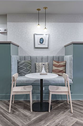 a small table with two chairs in a room with a couch