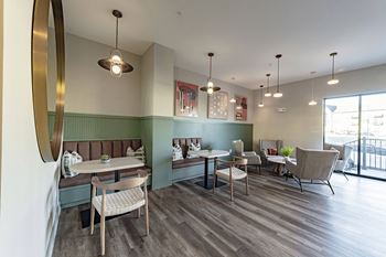 a dining room with tables and chairs and a large window