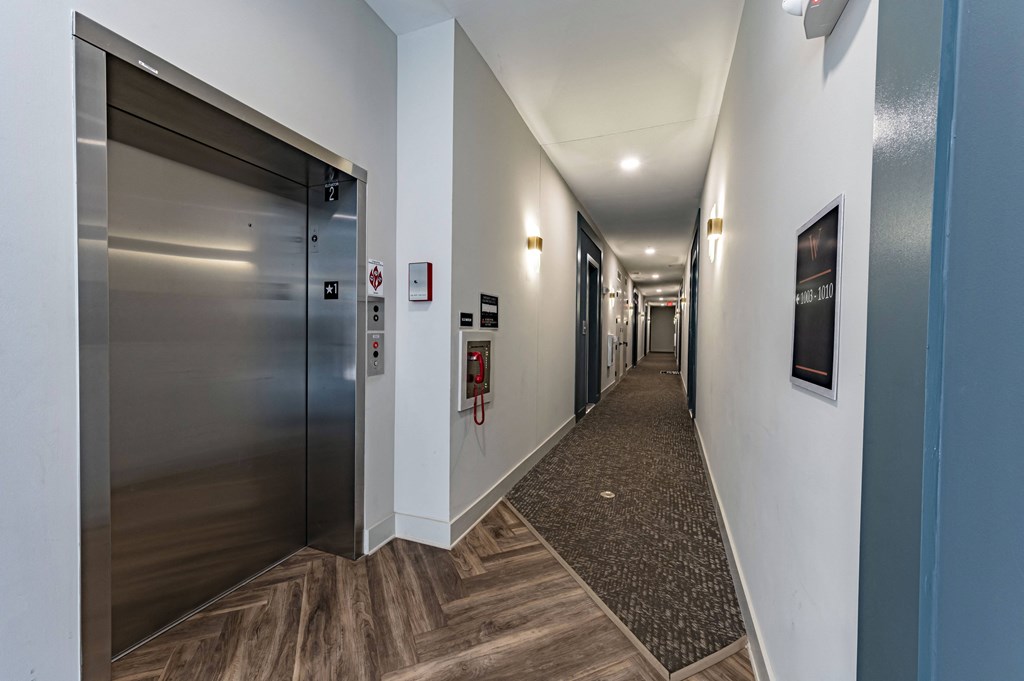 a hallway with elevators and doors in a building