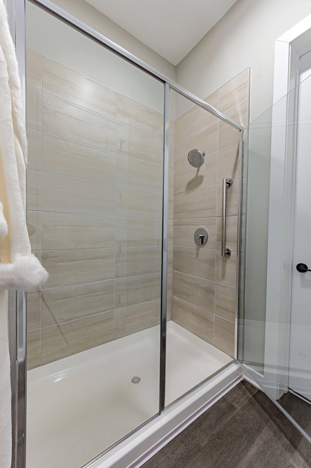 a shower with a glass door in a bathroom