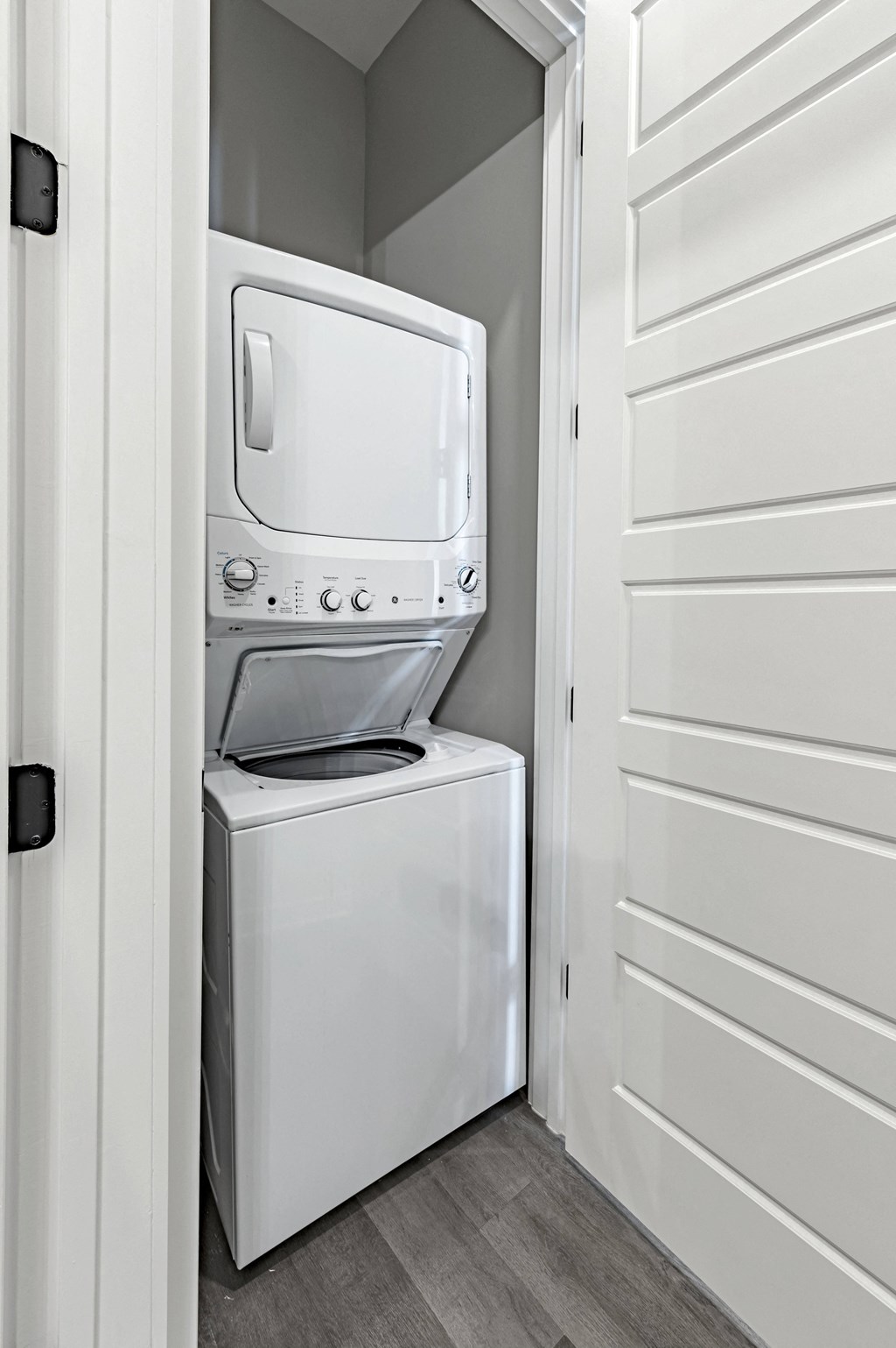 a white washer and dryer in a laundry room with a white door