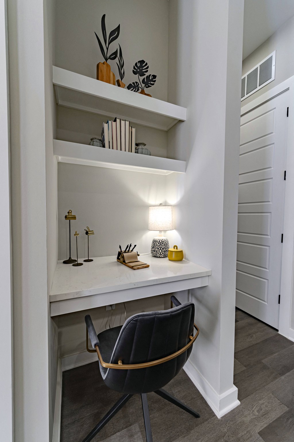 a workspace with a chair and a desk in a closet