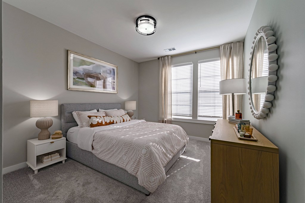 a bedroom with a bed and a dresser and a window