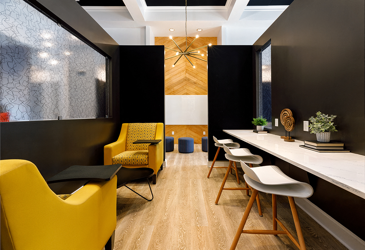a conference room with yellow chairs and a long table
