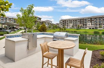 a patio with a table and chairs next to a pool