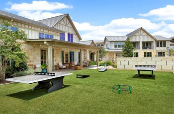 a backyard with a picnic table and a ping pong table
