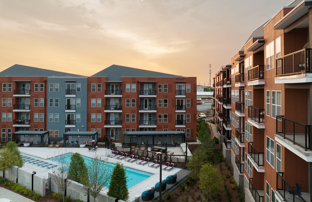 Apartment complex with a pool in the foreground.