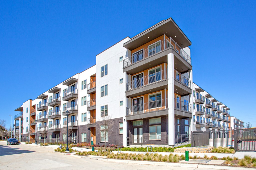 an apartment building with balconies and a blue sky