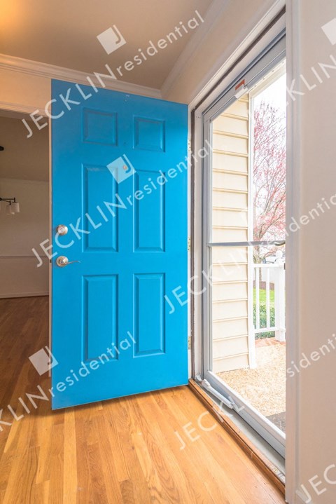 A blue door is open to a balcony.