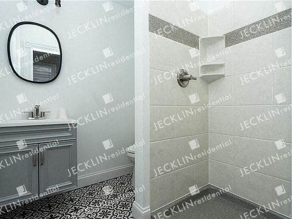 a bathroom with a sink a mirror and a shower