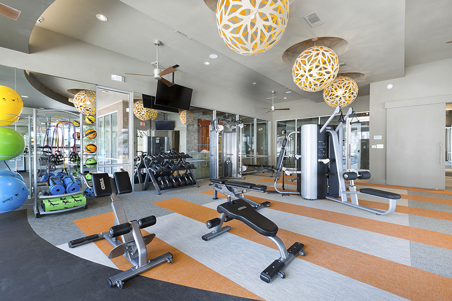 a gym with cardio equipment and weights at the renaissance atlantic yards apartments