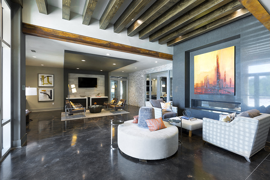 the living room has a large screen tv and a fireplace