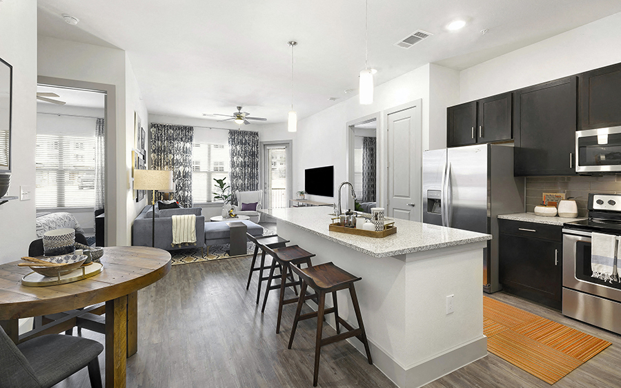 a kitchen with a large island with bar stools