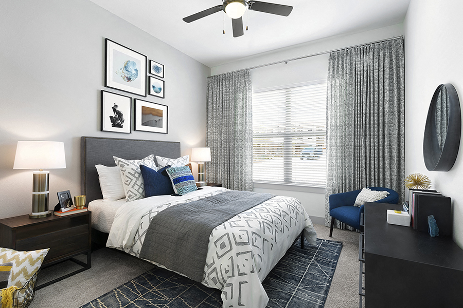 a bedroom with a bed and a ceiling fan