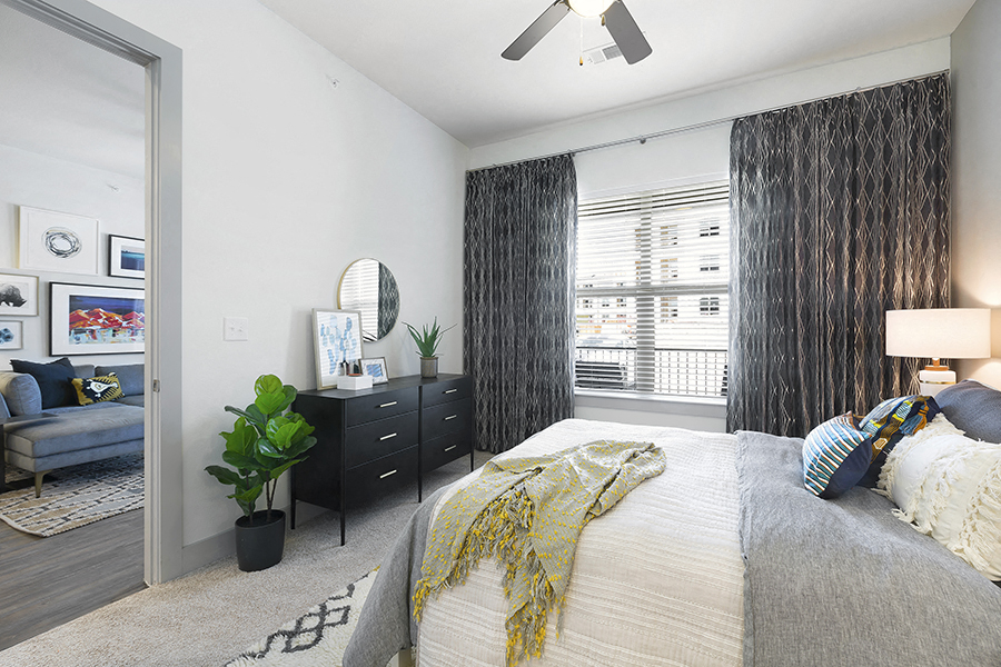 a bedroom with a large bed and a large window