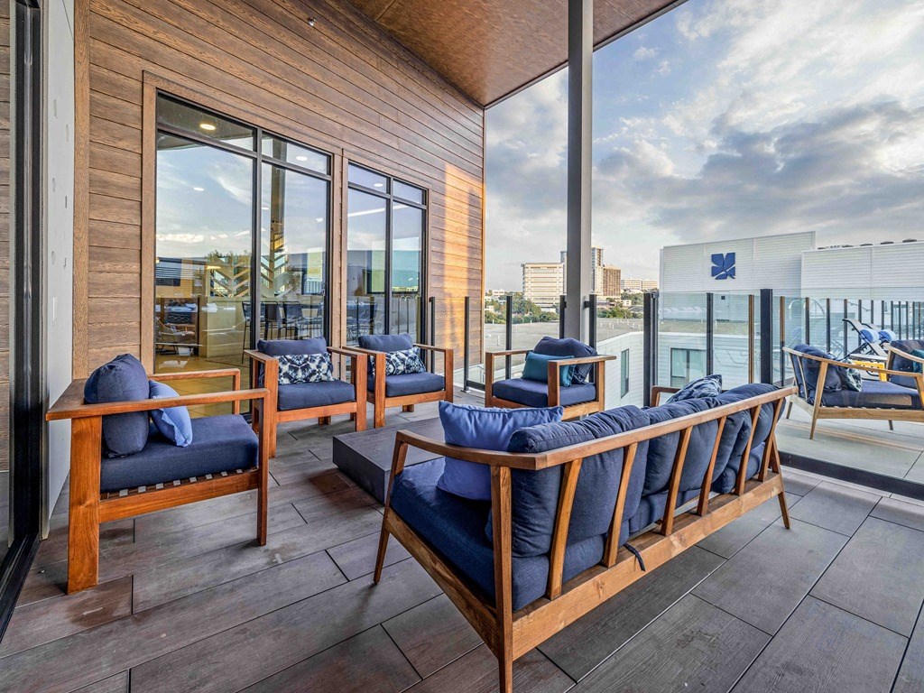 a living room with a balcony and a view of the city