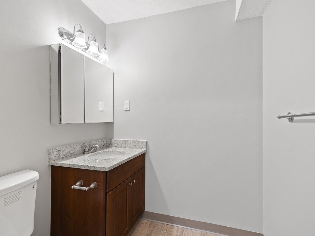 Empty bathroom with a sink and a toilet  at the River, Manchester, 03102