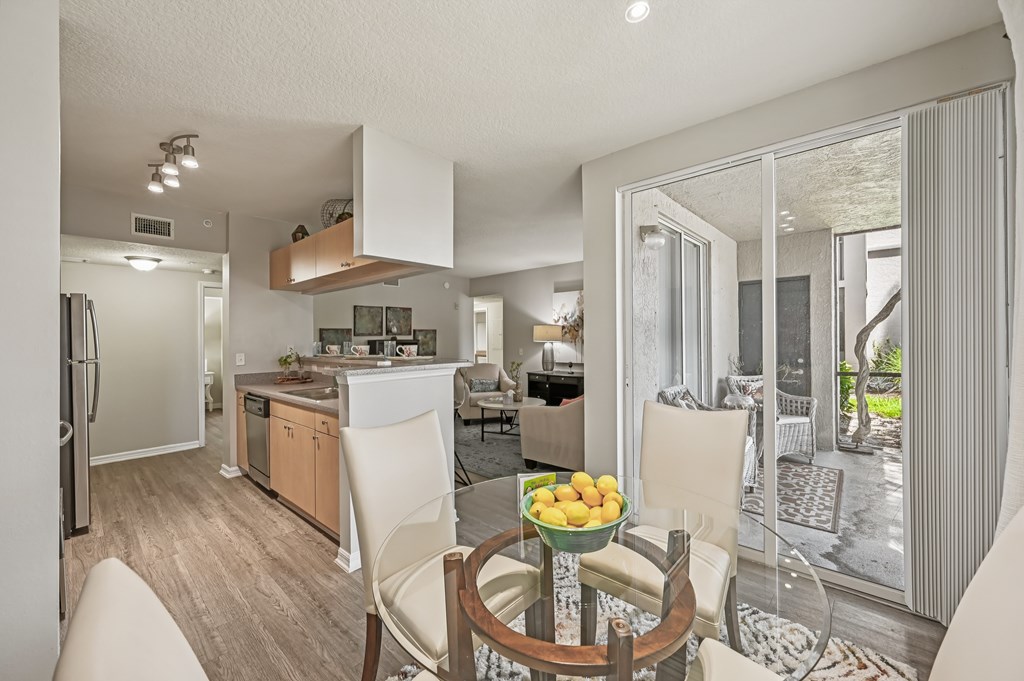 A modern kitchen with a dining table and chairs. at Heritage Bay, Jensen Beach