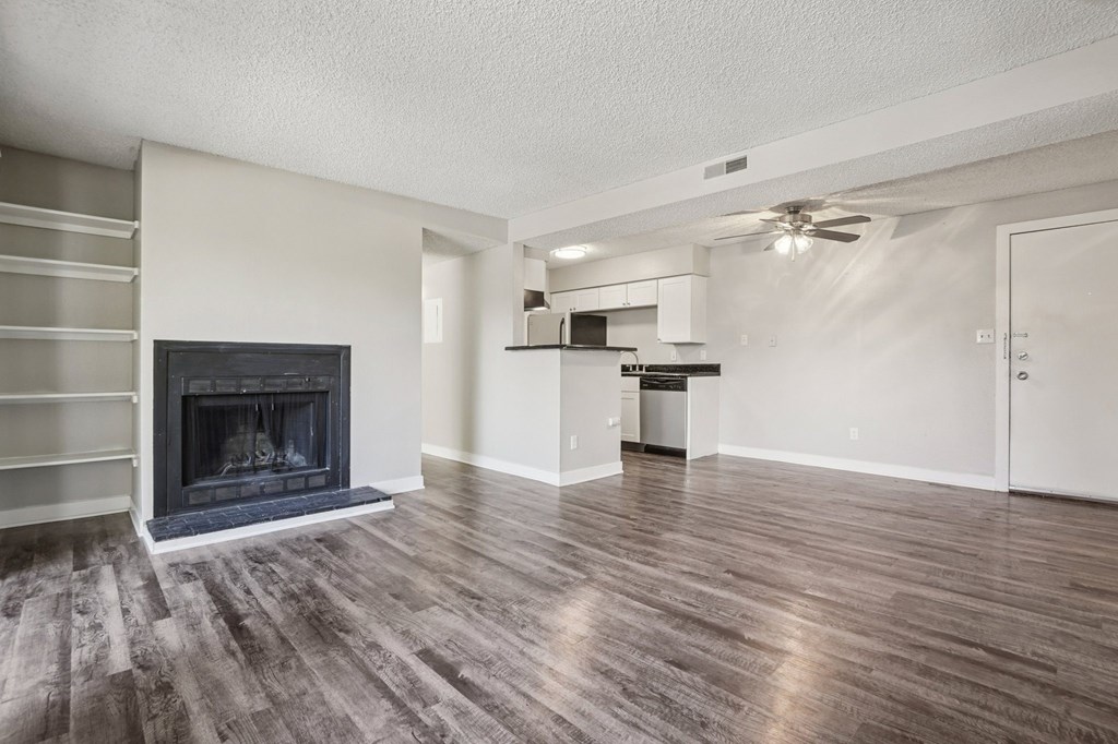 A modern living room with a fireplace and wooden floors.