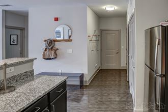 Kitchen with granite counter tops and a stainless steel refrigerator at Heritage at Oakley Square, Ohio, 45209