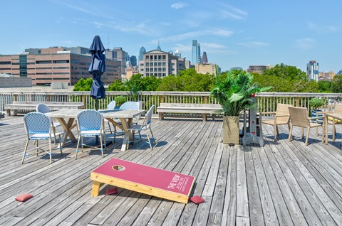 Roof deck with tables and chairs and a view of the city  at The View at Old City, Philadelphia