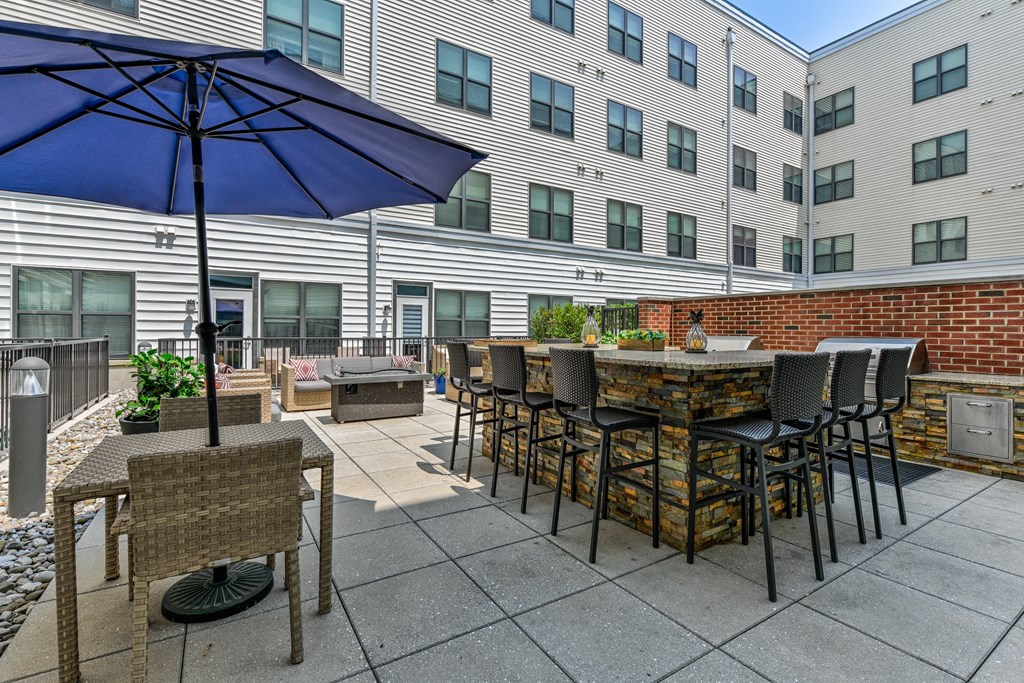 Patio with an umbrella and tables with chairs  at The View at Old City, Philadelphia