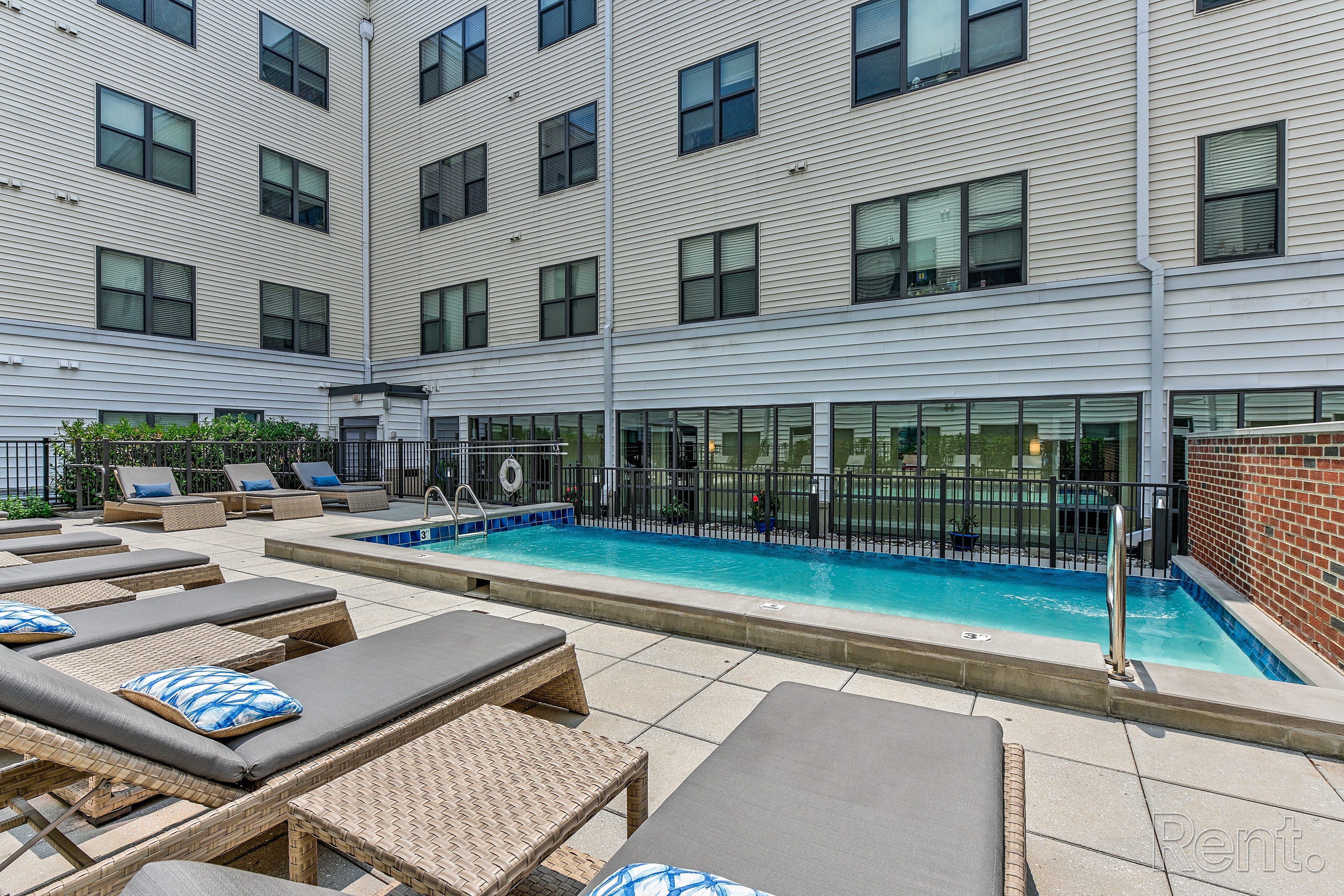 Pool with lounge chairs and a building in the background  at The View at Old City, Philadelphia