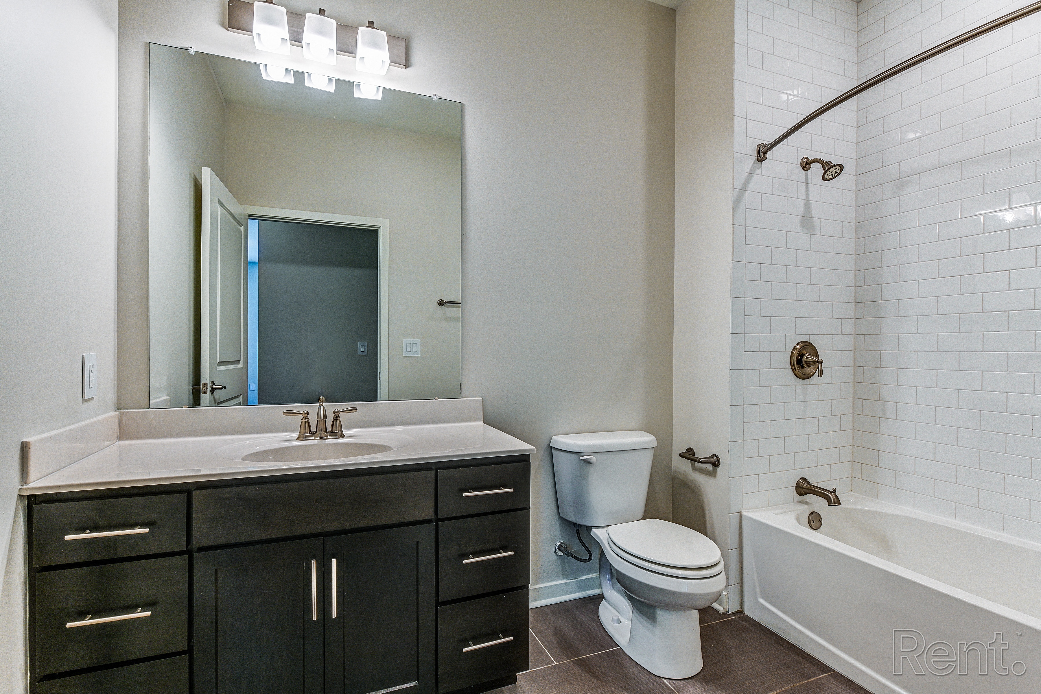 Bathroom with a large mirror and a bathtub with a shower head  at The View at Old City, Philadelphia